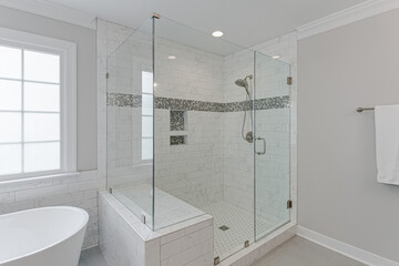 Modern Interior of Primary Bathroom with a White Floating Tub and Glass Luxury Soaking Shower
