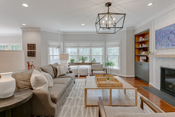 Interior of Luxury Modern Family Room with Farmhouse Home Decor and Furniture with Styled Shelf and Fireplace