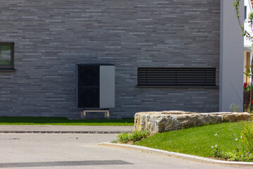 heat pump in a new building area with modern house facades