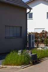 Obraz premium heat pump in a new building area with modern house facades