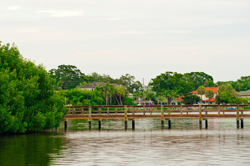 Boat dock beside coastal bay in St. Petersburg, Florida.  Sunny day with calm waters.