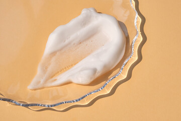 Soap foam on a light beige background.