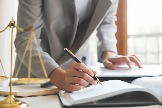 Business woman in suit or lawyer working on a documents.