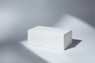 White paper box mockup in sunlight with shadow on white background.