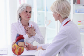 Woman complains on heart pain visiting doctor in hospital