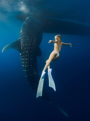 Whale shark and woman with fins in blue ocean. Shark underwater and beautiful sexy lady