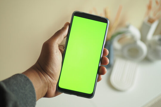  Young Man Hand Using Smart Phone With Green Screen At Home 