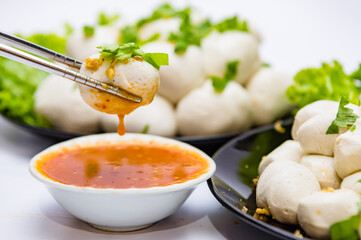 Fish balls ready to be served in a white container.