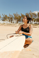 woman with surfboard on beach