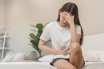 Fototapeta na wymiar Flatulence ulcer, asian young woman, girl hands in belly, stomachache from food poisoning, abdominal pain and digestive problem, gastritis or diarrhoea. Abdomen inflammation, menstrual period people.