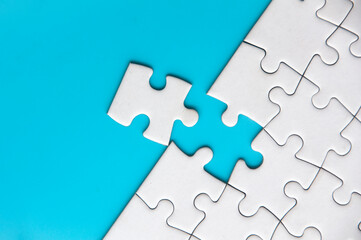 Fototapeta premium Separated jigsaw puzzle with customizable space for text. Copy space with blue background