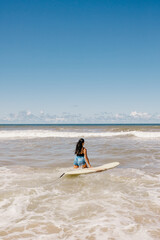 Fototapeta na wymiar woman with surfboard on beach