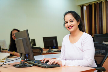 Indian woman working on computer at office.