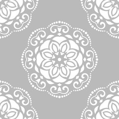 Floral white round ornament. Seamless abstract classic background with flowers. Pattern with repeating floral elements. Ornament for fabric, wallpaper and packaging