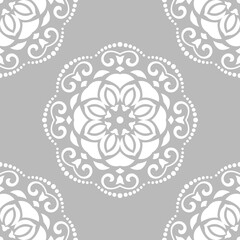 Floral white round ornament. Seamless abstract classic background with flowers. Pattern with repeating floral elements. Ornament for fabric, wallpaper and packaging