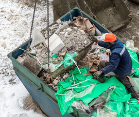 Unloading garbage at a construction site with a crane