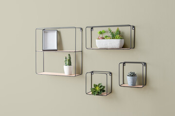 Three small square shelves filled with vibrant succulent plants, arranged in a decorative pattern