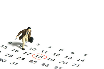 Miniature tiny people toy figure photography. A businessman running above calendar schedule...