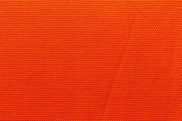 Orange color sports clothing fabric football shirt jersey texture and textile background.