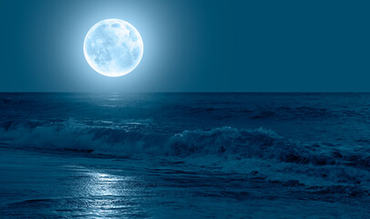 Night sky with moon in the sky dark strong sea wave in the background 
