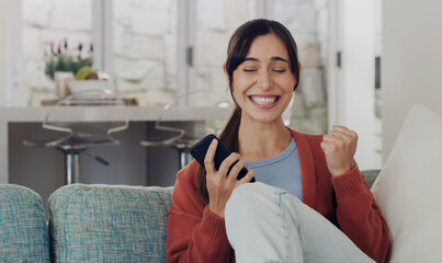 Woman, phone and celebration on sofa, winning and smile with success, profit or online gambling in...
