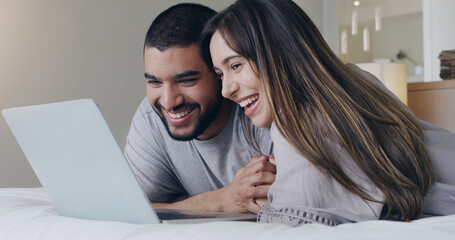 Happy, couple and watching movie on laptop in bedroom for online subscription, media download or relax together. Young man, woman and computer technology for streaming, internet or connection at home