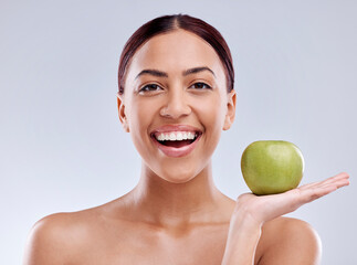 Apple, portrait or happy woman in studio eating on white background for healthy nutrition or clean diet. Smile, hand or excited girl showing natural organic green fruits for wellness or digestion