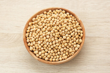 Soybean seeds (kacang kedelai) on wooden plate, food ingredients
