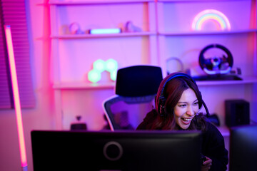 Asian e-sport woman laugh with fun emotional because of happy playing game when she live and share...