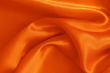 Orange fabric texture background, detail of silk or linen pattern.