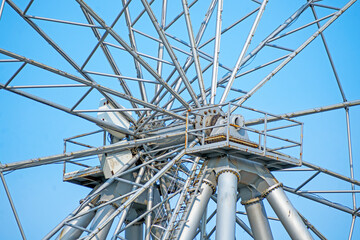 A fragment of a metal structure of a park attraction on a summer day