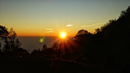 sunrise ambience in orange  sky with silhouette of natural landscape