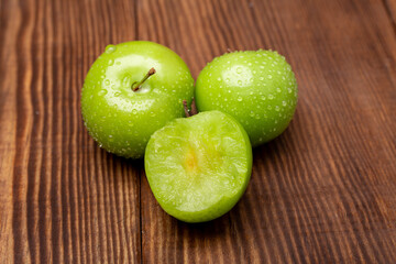Fresh and green plum on wood	