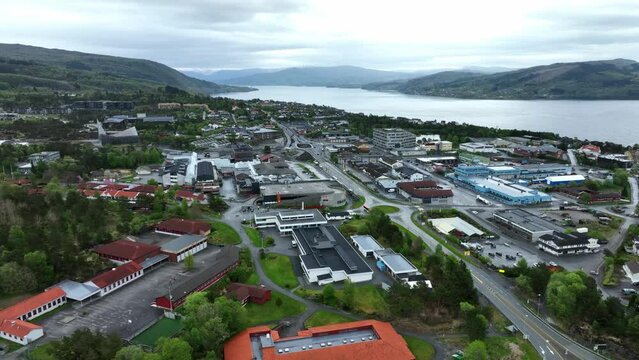 Knarvik city center with coastal road E-39 passing through and fjord Osterfjorden on right side - Aerial view