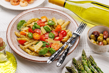 Italian pasta adorned with fresh tomatoes and aromatic basil