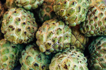 Lots of Sugar apple or custard apple in market, ripe exotic tropical fruits, healthy food, diet and vegetarian nutrition
