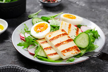 Healthy Ketogenic Paleo Meal, Grilled Halloumi with Lettuce, Radish, Cucumber, and Boiled Egg,...