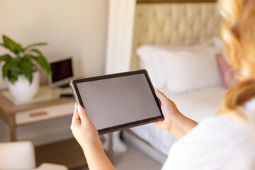 Cropped hands of plus size caucasian young woman using digital tablet at home, copy space