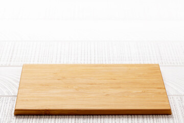 Wooden cutting board on white kitchen table