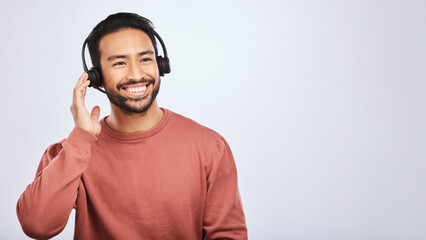Man with headset, call center and contact us with smile, mockup space and communication on studio...