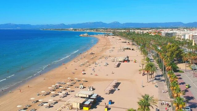 Beach, blue sea and palm trees in Salou city, Catalonia, Spain, Europe