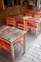 Fototapeta na wymiar bar outdoor orange chairs on cafe restaurant pub and steel wooden tables colorful terrace