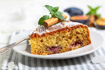 Piece of pie with blue plums.