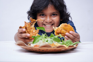 Asian little Girl Holding Fried Chicken with vegetable in white background