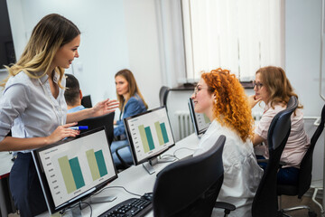 Educator and students in programming school