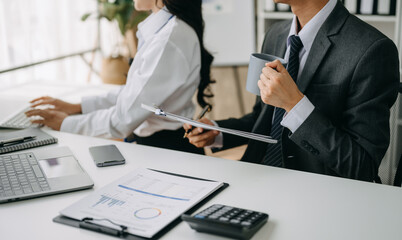  Team work process. Photo young business crew working with new startup project. Project managers meeting. Analyze plans, papers. .