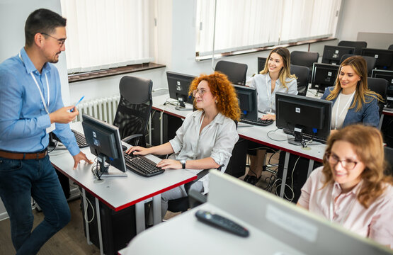 Educator and students in programming school
