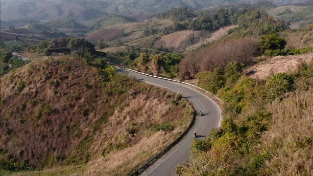 Unveiling Shot Of Bikers Riding Motorcycles On Rural road, NW Thailand Misc, Thailand