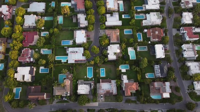Tilting top down view of a residential area with private swimming pools in the north of Buenos Aires