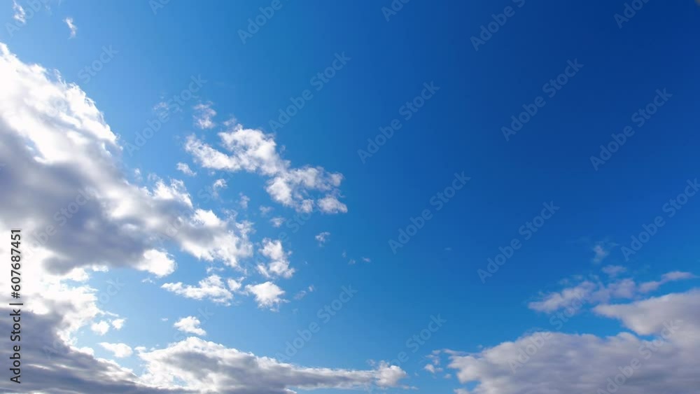Poster white clouds swiftly move across the azure sky. the blue sky is adorned with white clouds that glide